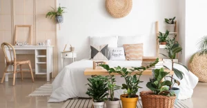 Cozy bedroom interior design with plants and a minimalist desk