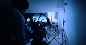 Behind the scenes of a Cinematography setup with camera, lighting, and crew in action