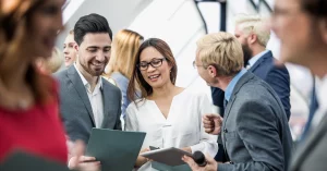 Group of event planners networking and discussing strategies at a corporate event